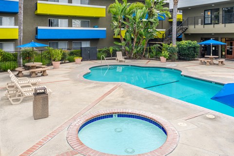 a large swimming pool with a building in the background